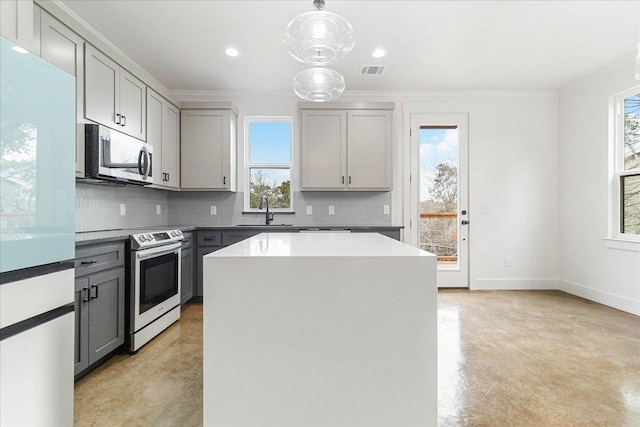 114 Shady Bluff Dr, Wimberley, TX 78676 - kitchen featuring appliances with stainless steel finishes, gray cabinetry, a sink, tasteful backsplash, and ornamental molding