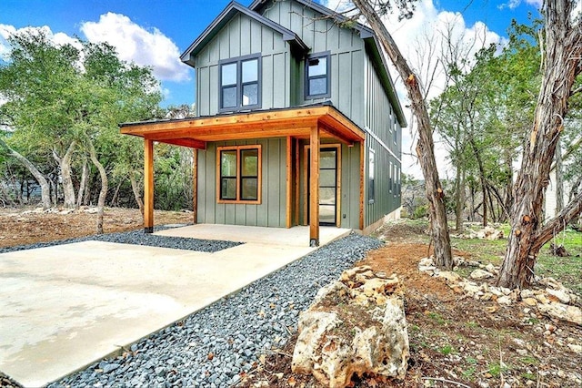 114 Shady Bluff Dr, Wimberley, TX 78676 - view of front of home featuring board and batten siding and covered porch