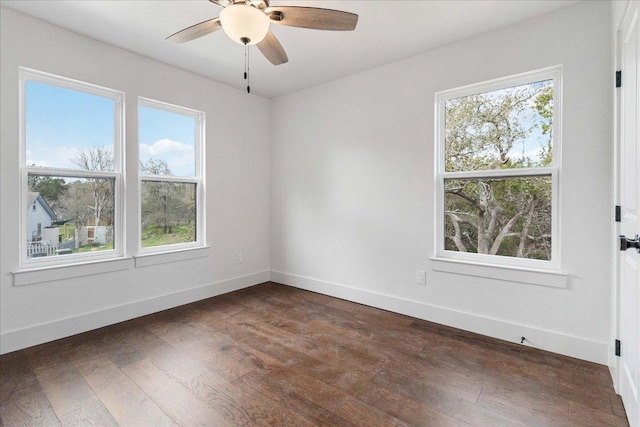 114 Shady Bluff Dr, Wimberley, TX 78676 - spare room featuring dark wood-style floors, ceiling fan, and baseboards