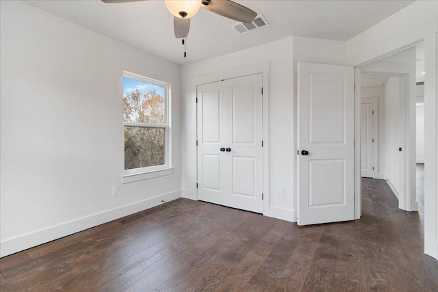 114 Shady Bluff Dr, Wimberley, TX 78676 - unfurnished bedroom with baseboards, a closet, dark wood-type flooring, and a ceiling fan