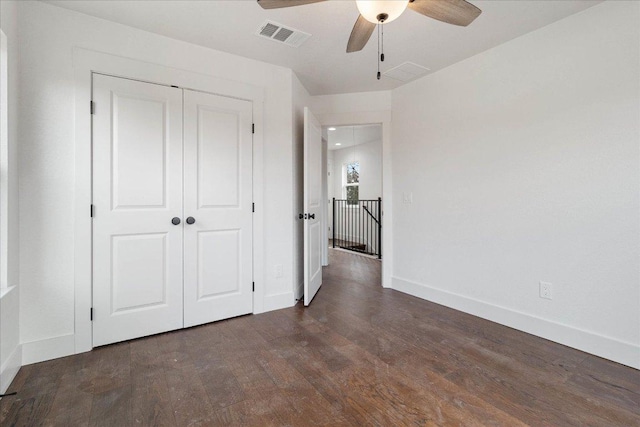 114 Shady Bluff Dr, Wimberley, TX 78676 - unfurnished bedroom featuring baseboards, wood finished floors, a closet, and ceiling fan