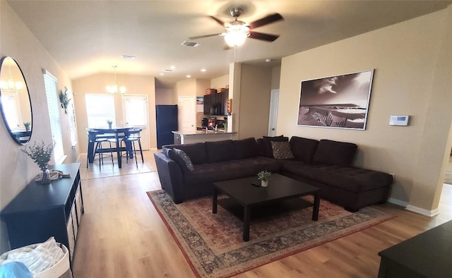 130 Navidad River Dr, Hutto, TX 78634 - living room with a chandelier, light wood-style floors, vaulted ceiling, baseboards, and ceiling fan
