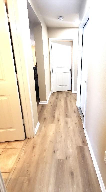 130 Navidad River Dr, Hutto, TX 78634 - hallway with light wood-type flooring and baseboards