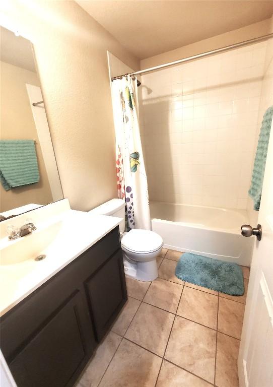 130 Navidad River Dr, Hutto, TX 78634 - full bathroom featuring toilet, vanity, shower / bathtub combination with curtain, and tile patterned flooring