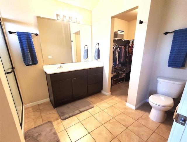 130 Navidad River Dr, Hutto, TX 78634 - bathroom with vanity, a walk in closet, tile patterned flooring, and toilet