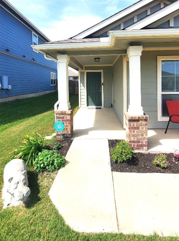 130 Navidad River Dr, Hutto, TX 78634 - entrance to property with a porch and a yard