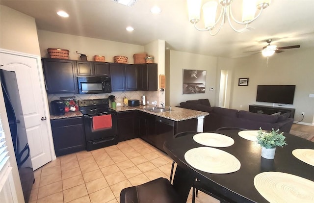 130 Navidad River Dr, Hutto, TX 78634 - kitchen with black appliances, open floor plan, decorative backsplash, a sink, and a chandelier