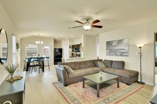 130 Navidad River Dr, Hutto, TX 78634 - living room featuring a chandelier, light wood-type flooring, a ceiling fan, and lofted ceiling