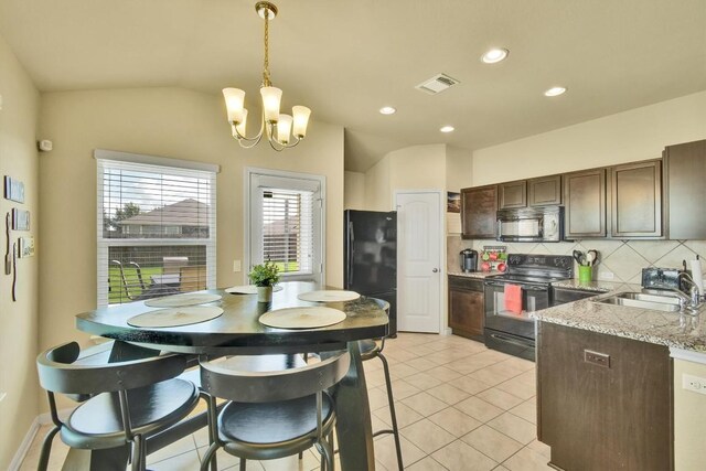 130 Navidad River Dr, Hutto, TX 78634 - kitchen with black appliances, a chandelier, decorative backsplash, dark brown cabinets, and pendant lighting