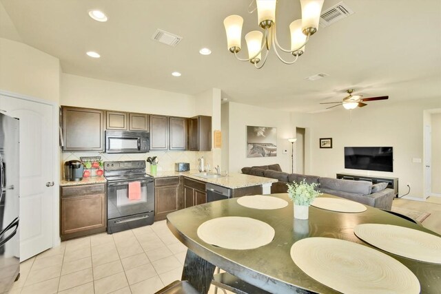 130 Navidad River Dr, Hutto, TX 78634 - kitchen with black appliances, decorative backsplash, dark brown cabinets, light tile patterned floors, and a chandelier