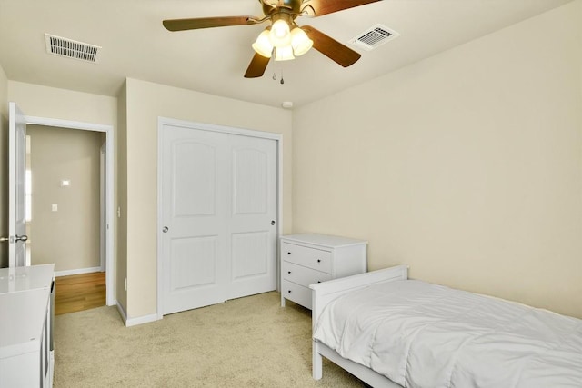130 Navidad River Dr, Hutto, TX 78634 - bedroom with light colored carpet, ceiling fan, and a closet