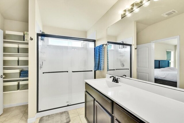 130 Navidad River Dr, Hutto, TX 78634 - ensuite bathroom featuring a shower stall, healthy amount of natural light, vanity, and tile patterned floors