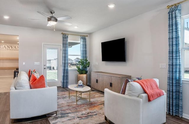 living room with healthy amount of natural light, wood finished floors, ceiling fan, recessed lighting, and baseboards