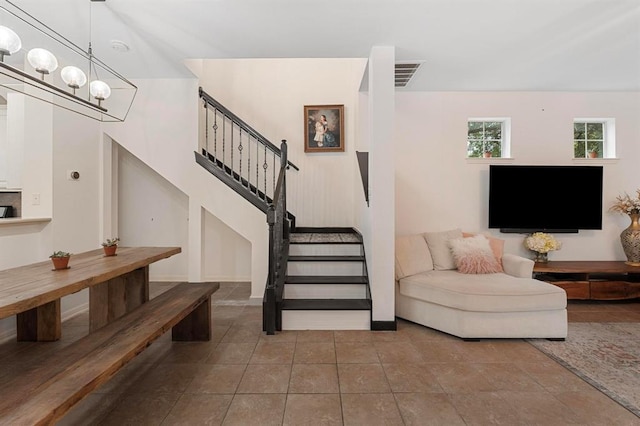 11000 Anderson Mill Rd Unit 84, Austin, TX 78750 - living room featuring stairs, tile patterned flooring, and a chandelier