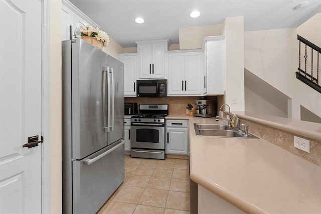 11000 Anderson Mill Rd Unit 84, Austin, TX 78750 - kitchen with stainless steel appliances, a sink, white cabinetry, light countertops, and recessed lighting