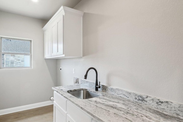 4007 Aerie St, Salado, TX 76571 - washroom with cabinet space, baseboards, electric dryer hookup, light wood-style floors, and hookup for a washing machine