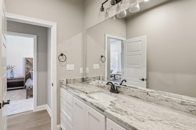 4007 Aerie St, Salado, TX 76571 - ensuite bathroom with wood finished floors, vanity, and baseboards