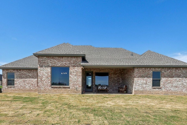 4007 Aerie St, Salado, TX 76571 - rear view of house featuring roof with shingles, brick siding, and a yard