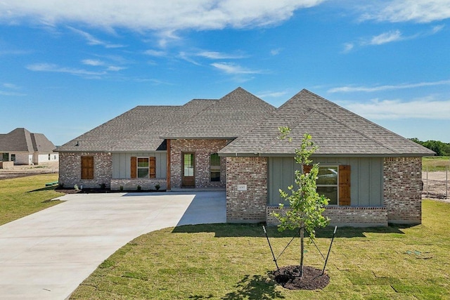 4007 Aerie St, Salado, TX 76571 - view of front facade with brick siding, board and batten siding, a shingled roof, concrete driveway, and a front yard