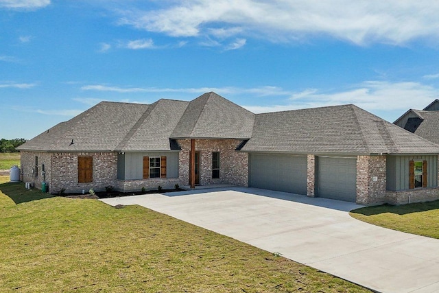4007 Aerie St, Salado, TX 76571 - french country home featuring an attached garage, brick siding, and a front lawn