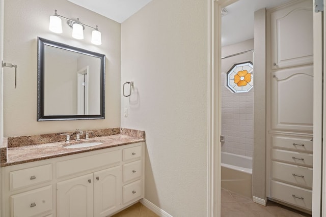 10109 Vaquero Trl, Austin, TX 78759 - bathroom featuring vanity, tile patterned floors, baseboards, and bathtub / shower combination