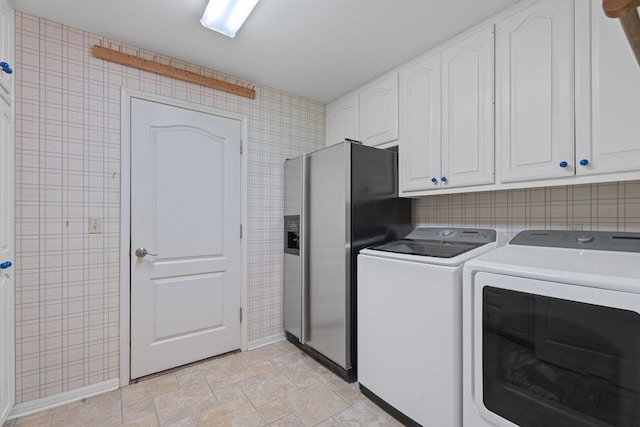10109 Vaquero Trl, Austin, TX 78759 - washroom with washing machine and dryer, baseboards, cabinet space, and wallpapered walls