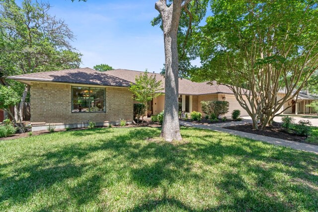 10109 Vaquero Trl, Austin, TX 78759 - ranch-style home with brick siding, a front yard, and a shingled roof