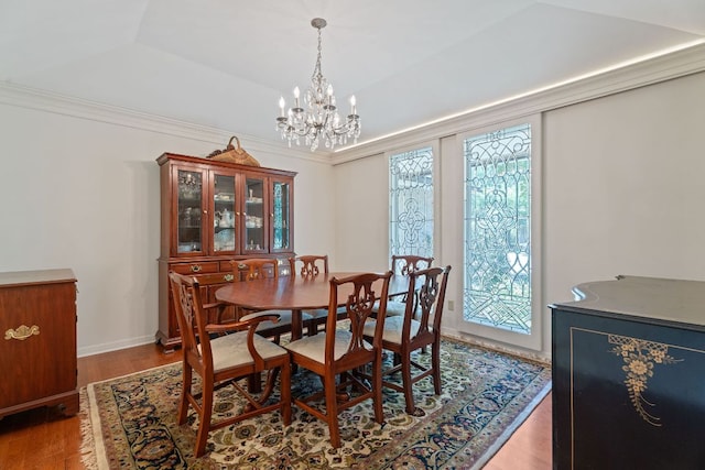 10109 Vaquero Trl, Austin, TX 78759 - dining room featuring a chandelier, wood finished floors, and a tray ceiling