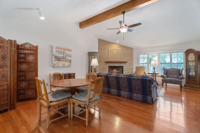 10109 Vaquero Trl, Austin, TX 78759 - dining area with ceiling fan, wood finished floors, and a brick fireplace