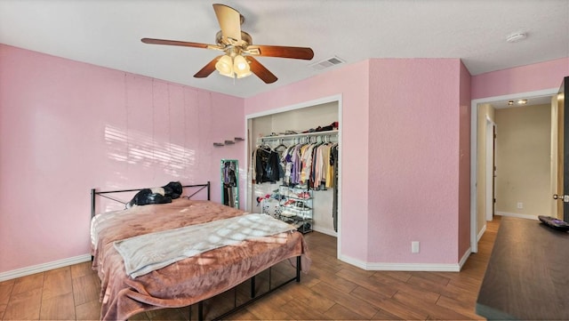 bedroom featuring wood finished floors, baseboards, a closet, and ceiling fan