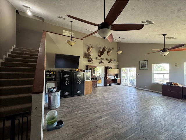 21424 Martin Ln, Pflugerville, TX 78660 - living area with a ceiling fan, a textured ceiling, wood finished floors, healthy amount of natural light, and stairway