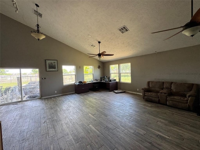 21424 Martin Ln, Pflugerville, TX 78660 - living room featuring a ceiling fan, wood finished floors, a textured ceiling, baseboards, and high vaulted ceiling