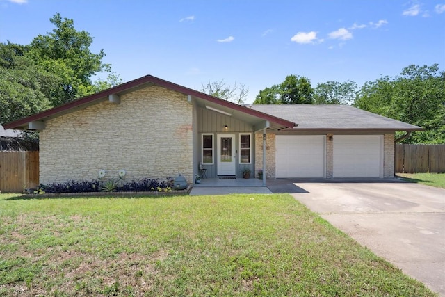 view of front facade featuring a garage, driveway, brick siding, and board and batten siding