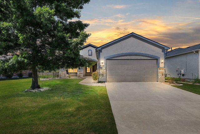 126 Cathedral Mountain Pass, Georgetown, TX 78633 - view of front of house featuring stone siding, concrete driveway, a garage, and a lawn