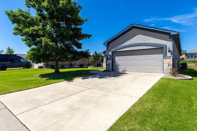 126 Cathedral Mountain Pass, Georgetown, TX 78633 - view of side of home featuring stone siding, a yard, driveway, an attached garage, and central AC unit