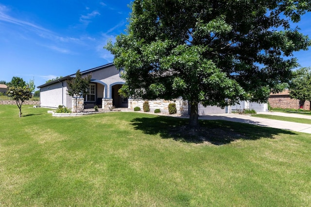 126 Cathedral Mountain Pass, Georgetown, TX 78633 - obstructed view of property with a front yard, stucco siding, stone siding, concrete driveway, and a garage
