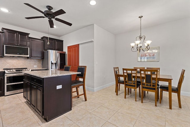 126 Cathedral Mountain Pass, Georgetown, TX 78633 - kitchen featuring appliances with stainless steel finishes, backsplash, a ceiling fan, recessed lighting, and a center island