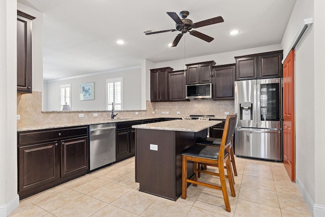 126 Cathedral Mountain Pass, Georgetown, TX 78633 - kitchen with appliances with stainless steel finishes, a sink, a center island, backsplash, and recessed lighting
