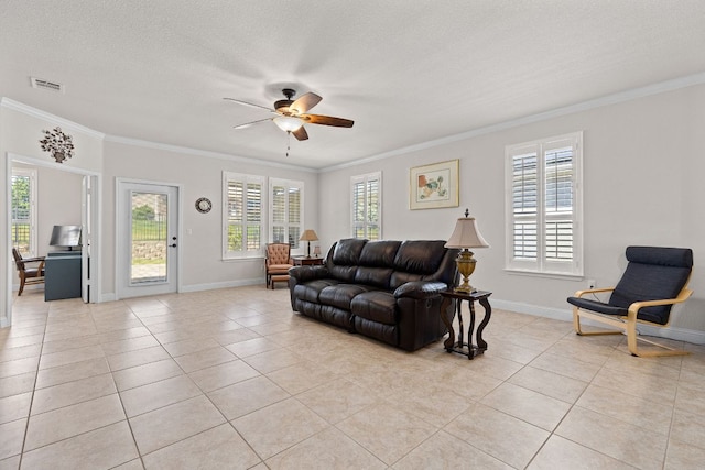 126 Cathedral Mountain Pass, Georgetown, TX 78633 - living room featuring light tile patterned floors, ceiling fan, crown molding, baseboards, and a textured ceiling