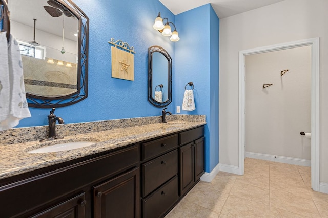 126 Cathedral Mountain Pass, Georgetown, TX 78633 - full bath with double vanity, tile patterned floors, baseboards, and a tile shower