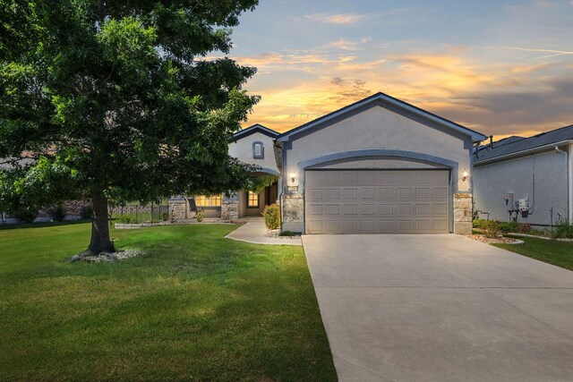 126 Cathedral Mountain Pass, Georgetown, TX 78633 - view of front of house with stone siding, driveway, a garage, and a front yard