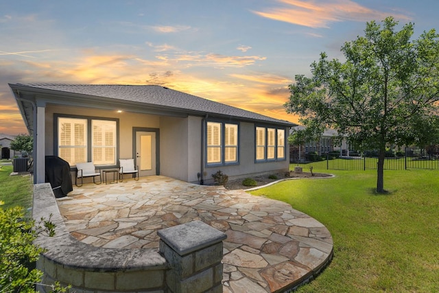 126 Cathedral Mountain Pass, Georgetown, TX 78633 - back of house at dusk featuring a patio area, stucco siding, and central AC unit