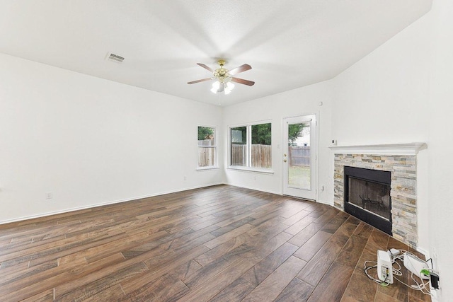 13213 Marie Ln, Manor, TX 78653 - unfurnished living room with dark wood finished floors, ceiling fan, and a fireplace