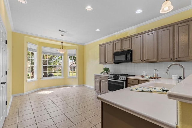 409 Rio Grande Loop, Georgetown, TX 78633 - kitchen with black microwave, stainless steel range with gas stovetop, a sink, light tile patterned flooring, and light countertops
