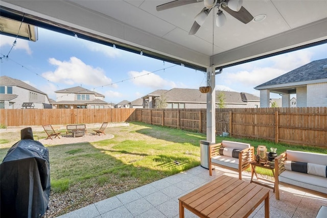 view of yard featuring a patio area, ceiling fan, a residential view, and an outdoor living space with a fire pit