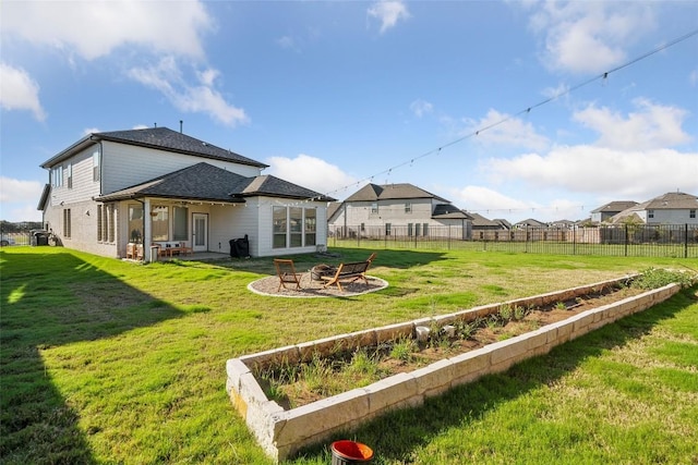 rear view of property with an outdoor fire pit, a shingled roof, and a patio area