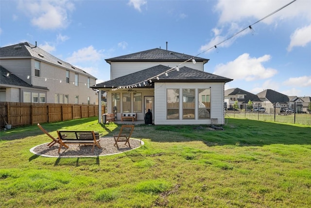 rear view of property featuring a patio, roof with shingles, and a ceiling fan