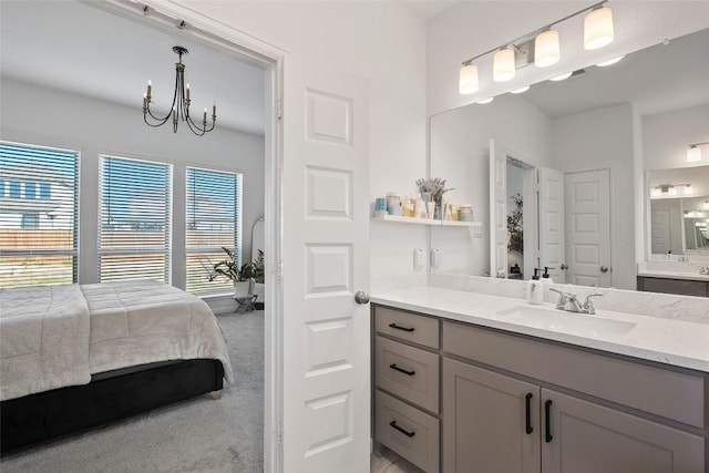 full bath with a chandelier, vanity, and ensuite bath