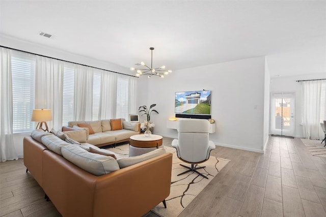 208 Dycus Bnd, Liberty Hill, TX 78642 - living room with a chandelier and light wood-style flooring