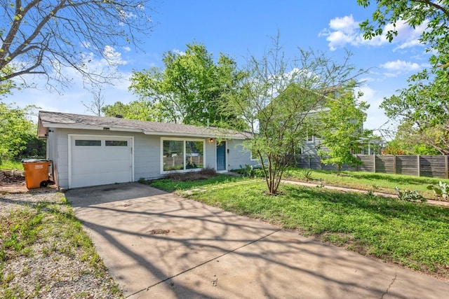 single story home with driveway, fence, and an attached garage